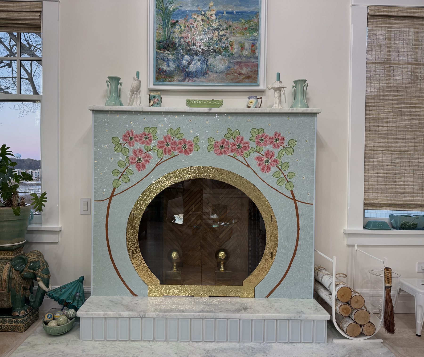 A hand-built stone mosaic fireplace surround and hearth, with concentric bands of individually shaped tile framing marble panels, from a Leslie Guerci project